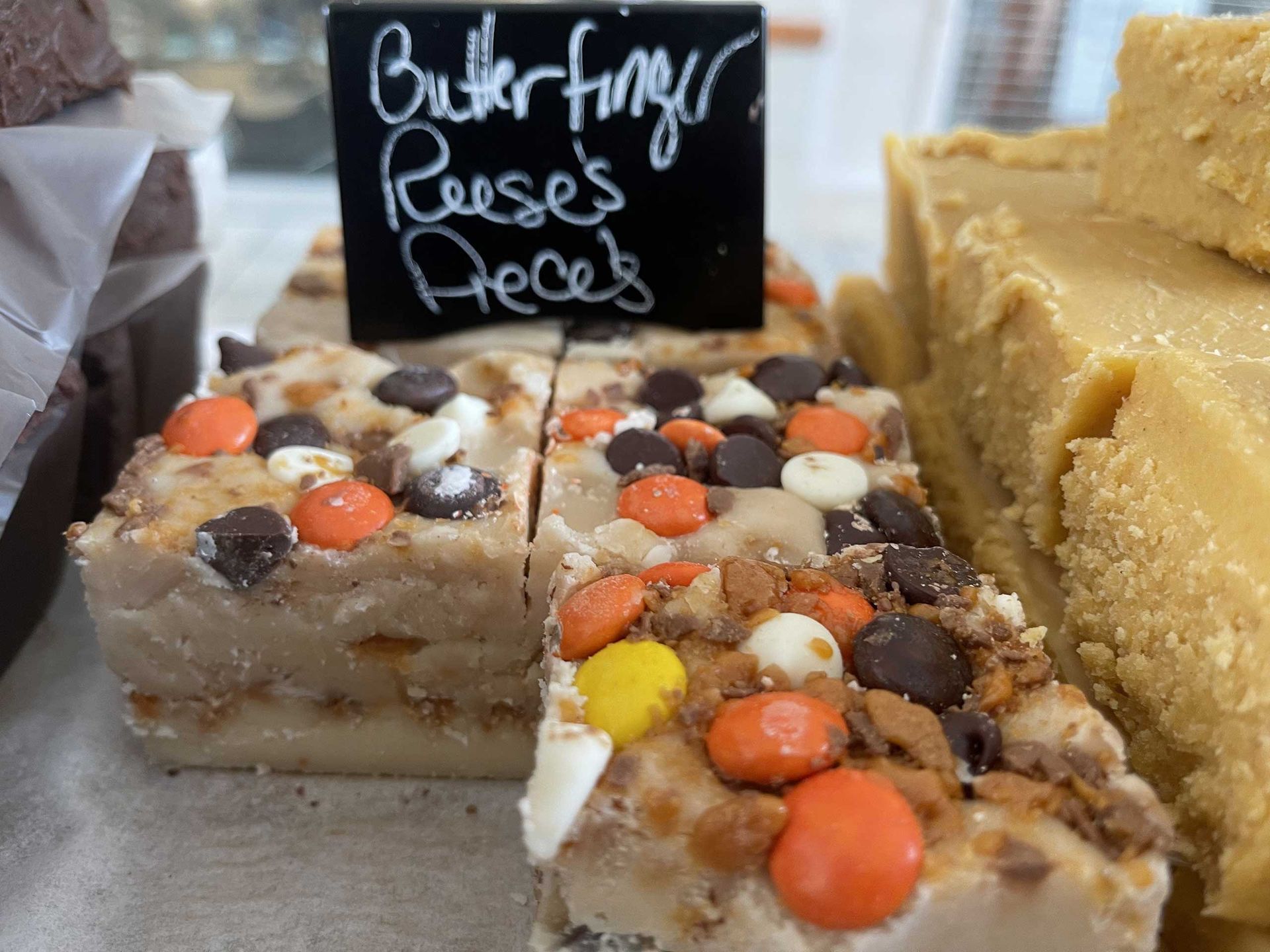 Fudge with Reese's Pieces and chocolate chips, displayed with a Butterfinger/Reese's Pieces sign.