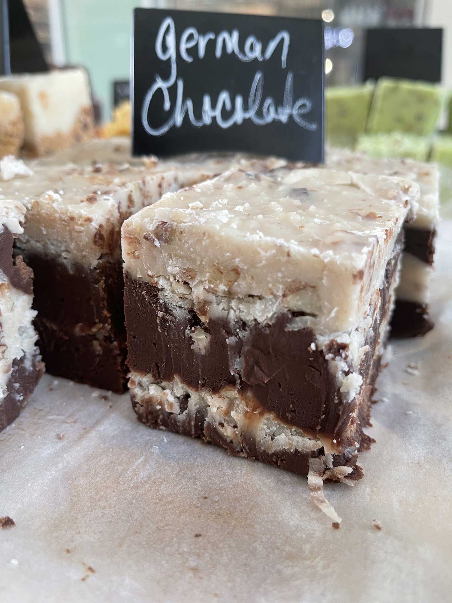 German chocolate fudge with a coconut pecan topping on display.