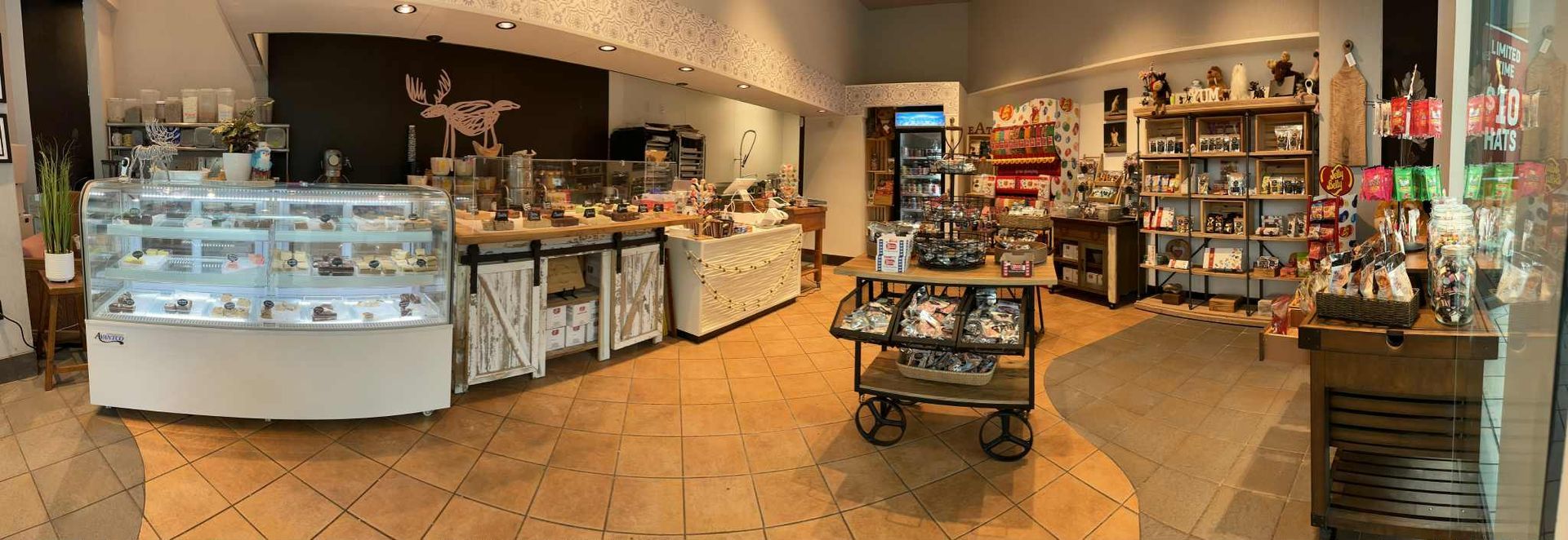 Interior of a retail shop with display cases of food items and merchandise.