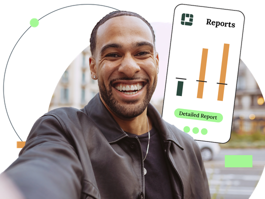 Smiling man taking a selfie, phone showing financial reports in front of an urban background.