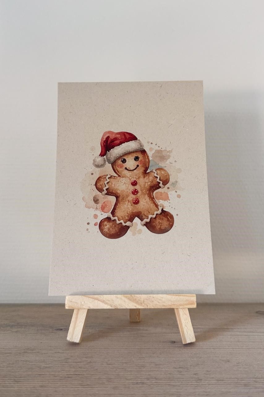 Peperkoekenmannetje met kerstmuts op canvas ezel. Illustratie in aquarelstijl.