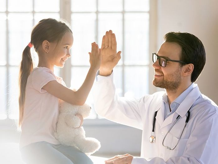 Happy Child High Five with a Male Doctor — Hammond, LA — Cypress Pointe Health Care