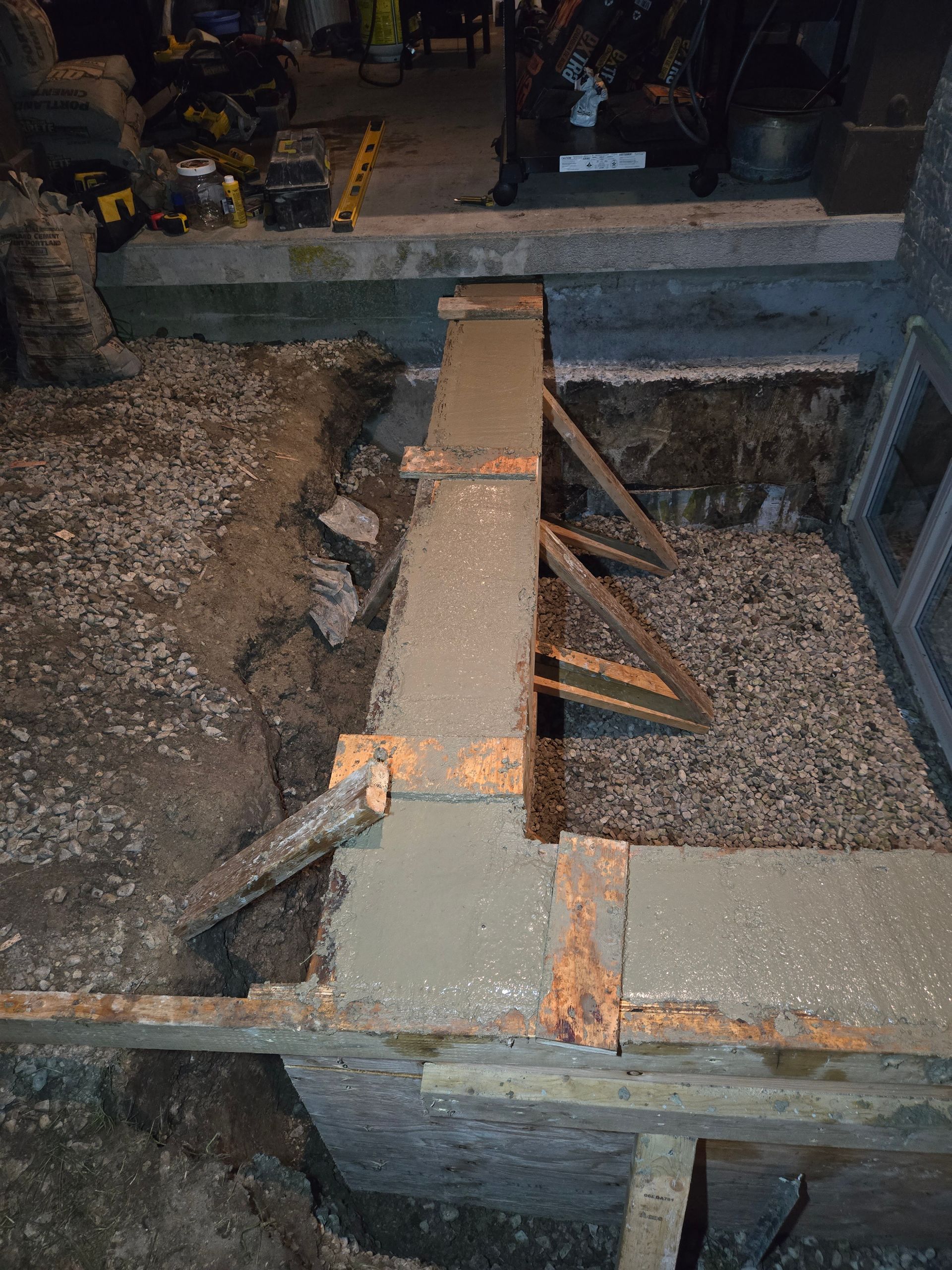 A concrete wall is being built in a basement.
