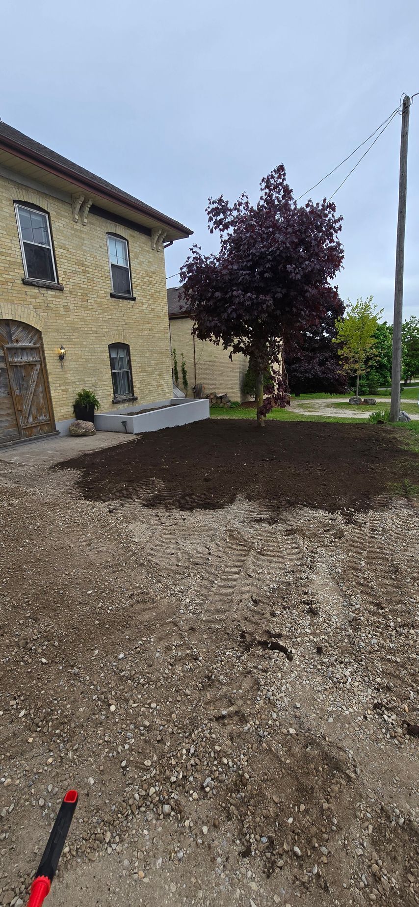 A large house with a lot of dirt in front of it.