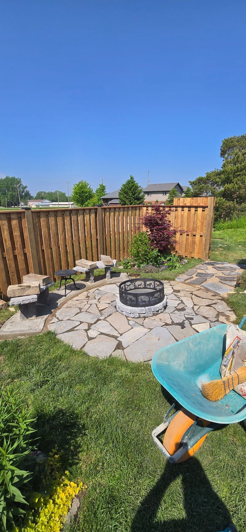 There is a fire pit in the middle of the backyard.