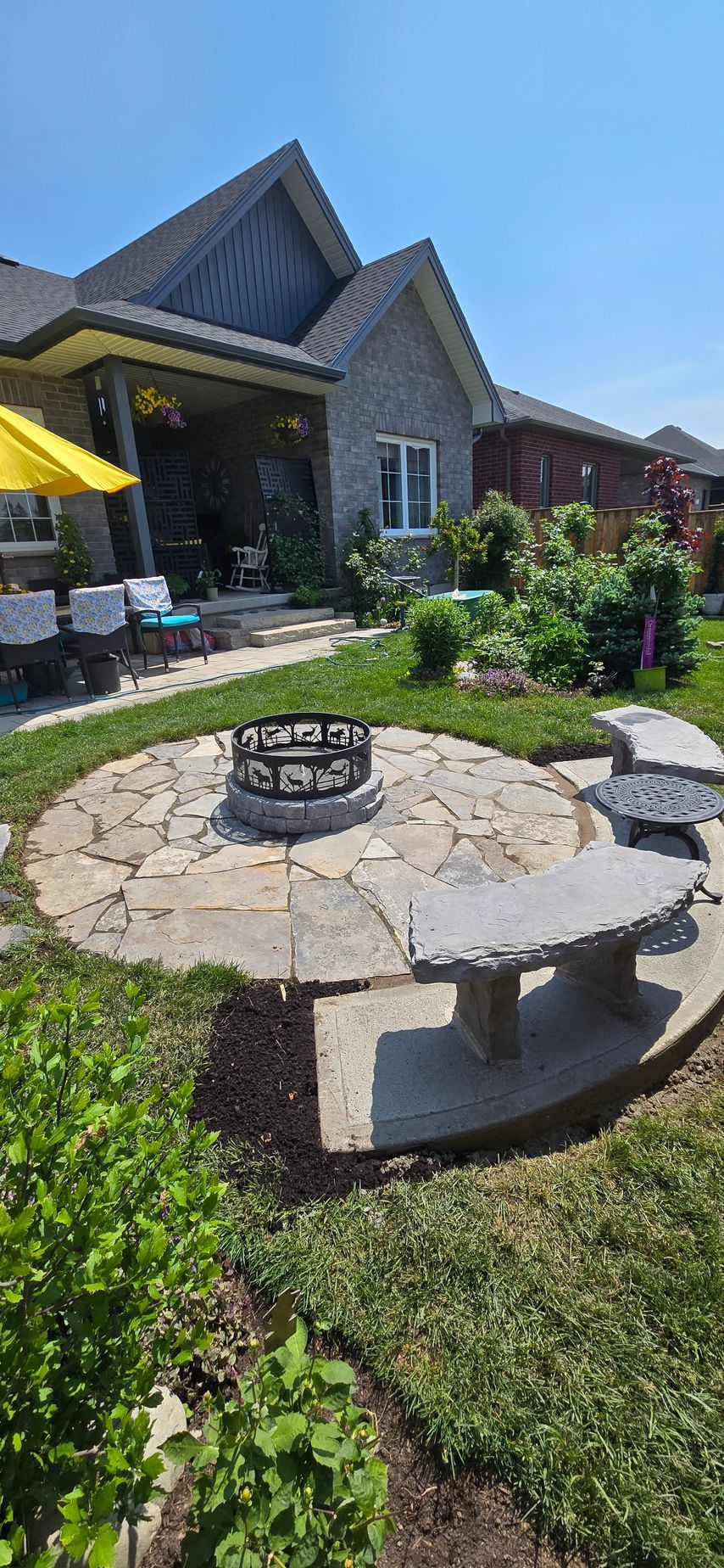 There is a fire pit in the middle of the backyard.