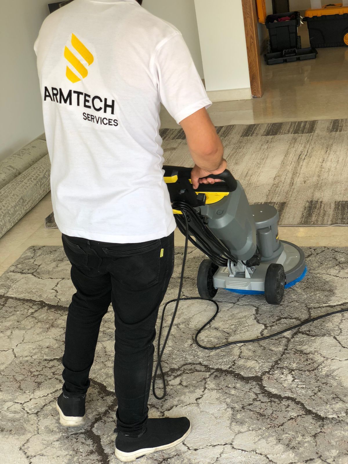 A person is cleaning a carpet with a machine.
