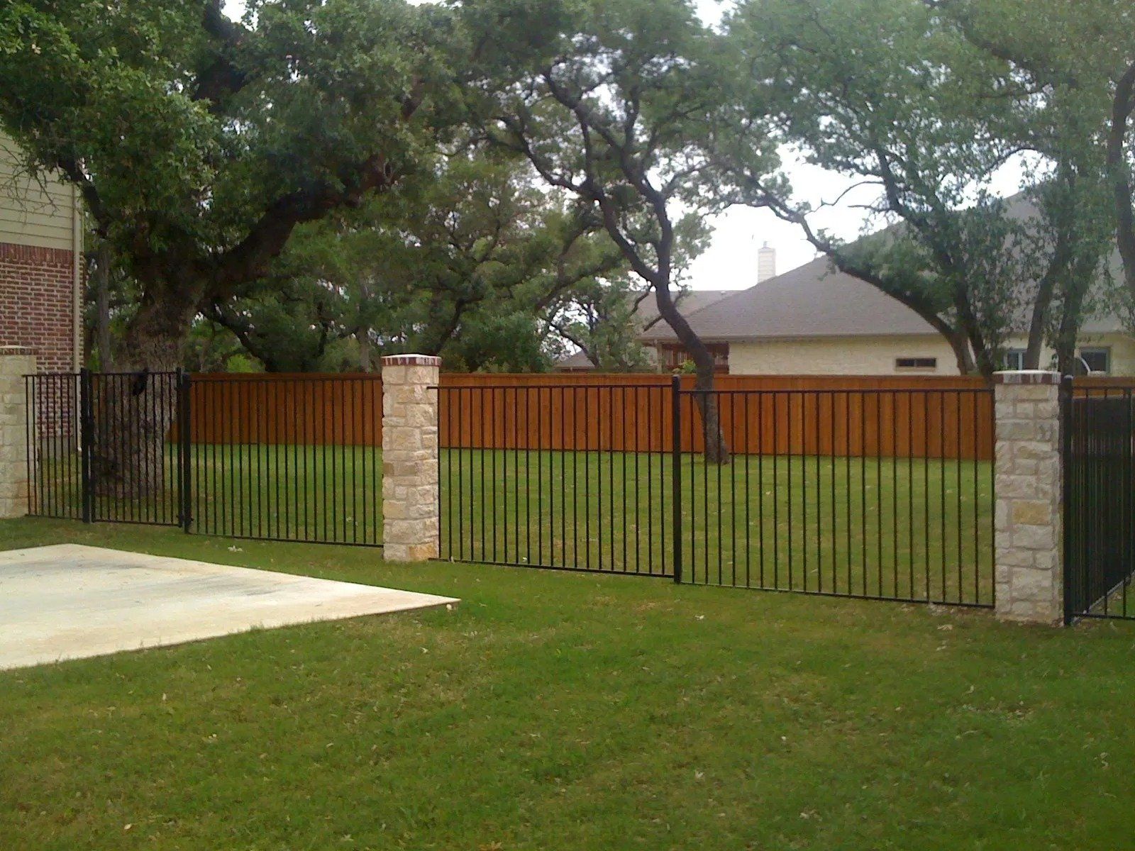 Wrought Iron with Stone Columns — New Braunfels, TX — Shelton’s Outback Fence Co