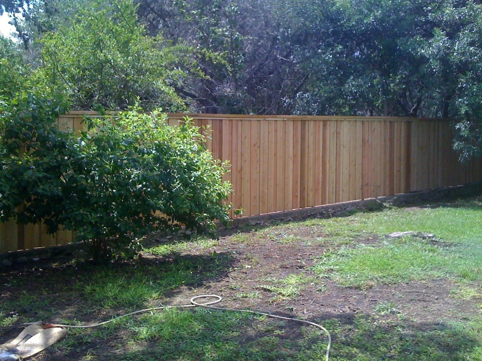 Cedar Privacy Fence with Cap and Trim — New Braunfels, TX — Shelton’s Outback Fence Co