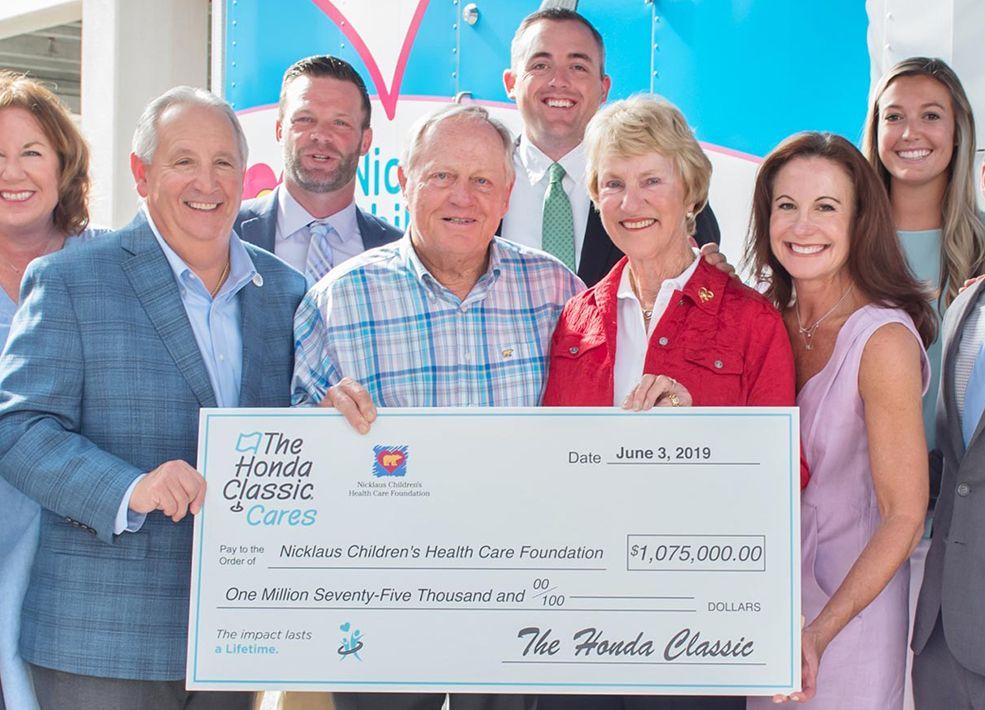 A group of people are holding a large check.