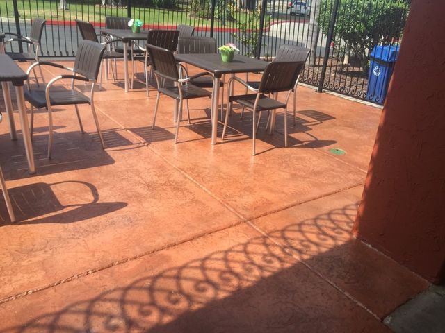 A patio with tables and chairs on a sunny day