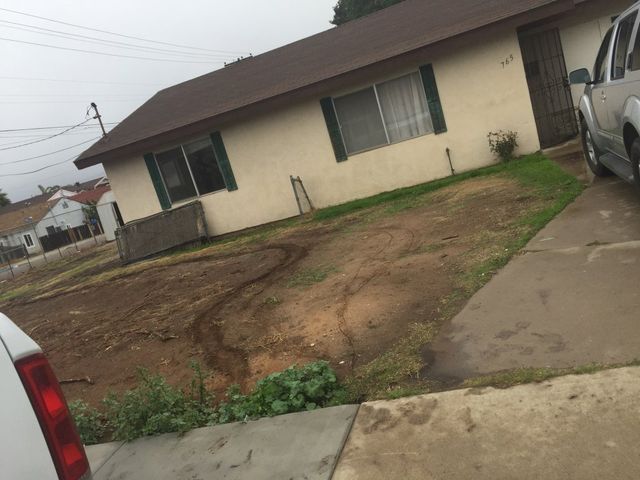 A white truck is parked in front of a house