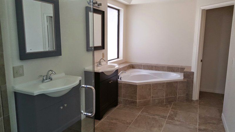 bathroom with inset tub and walk in shower