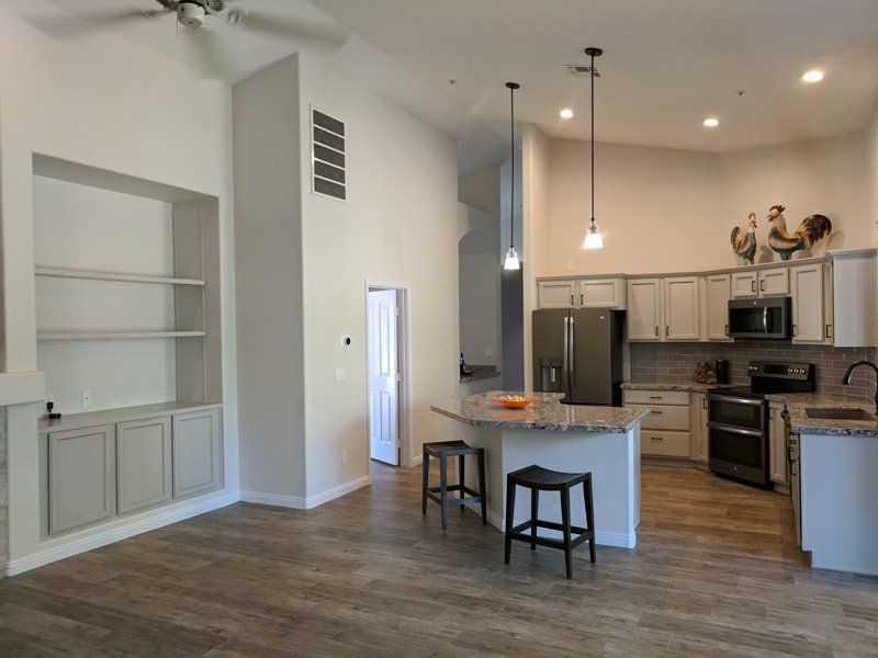 open kitchen with angular island in the middle next to wall