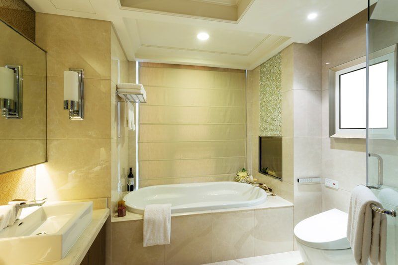 yellow bathroom with tub next to toilet