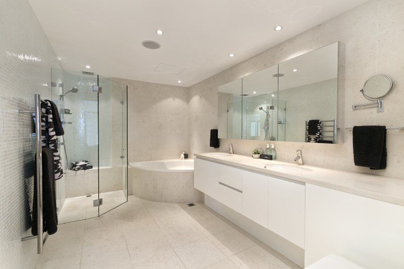 white bathroom with inset tub and walk in shower