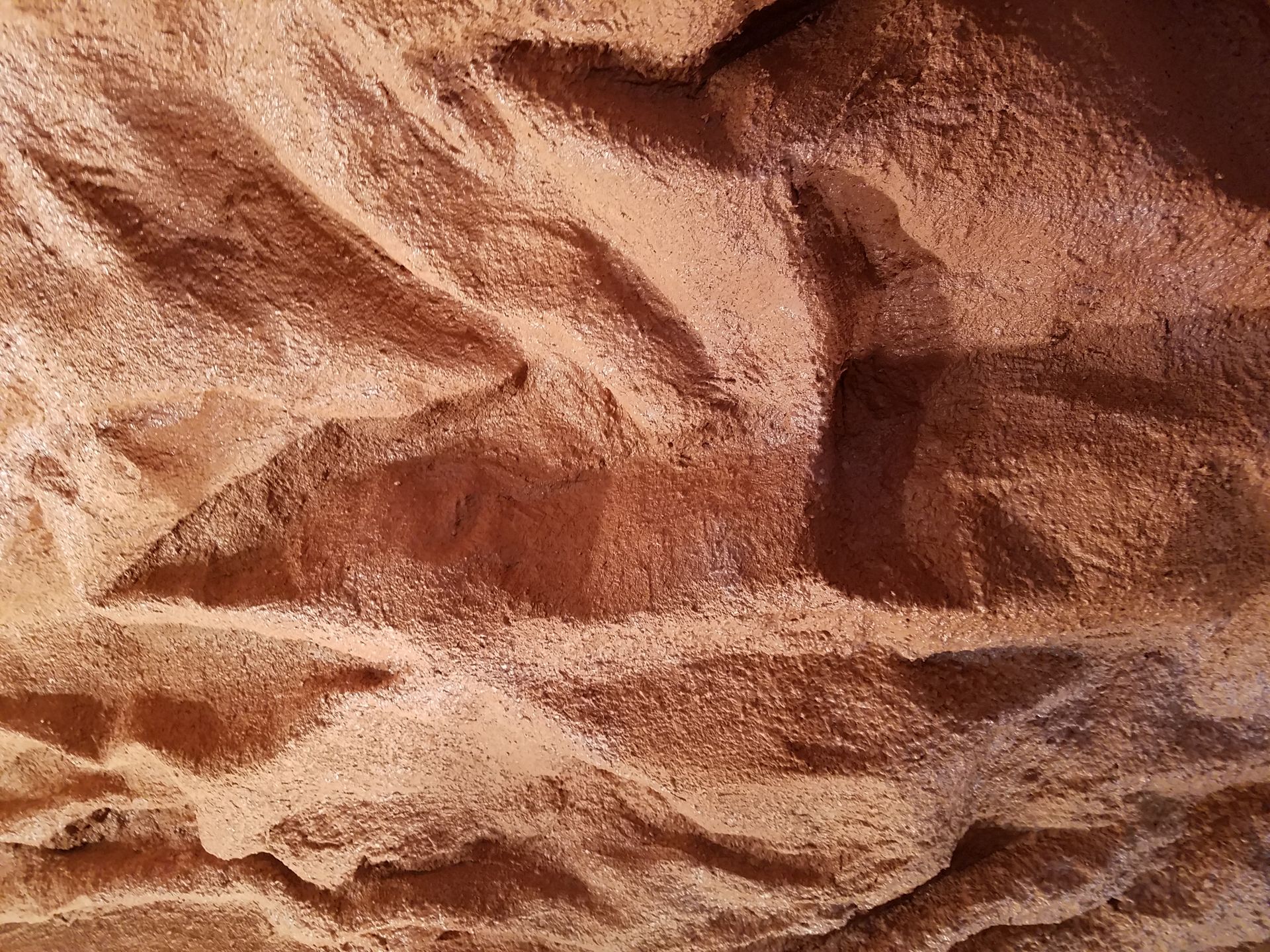 A close up of a rock wall with a pattern on it.