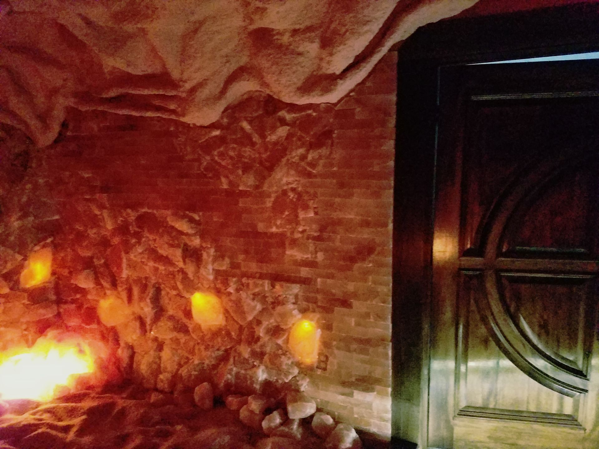 A room with a brick wall and candles in it