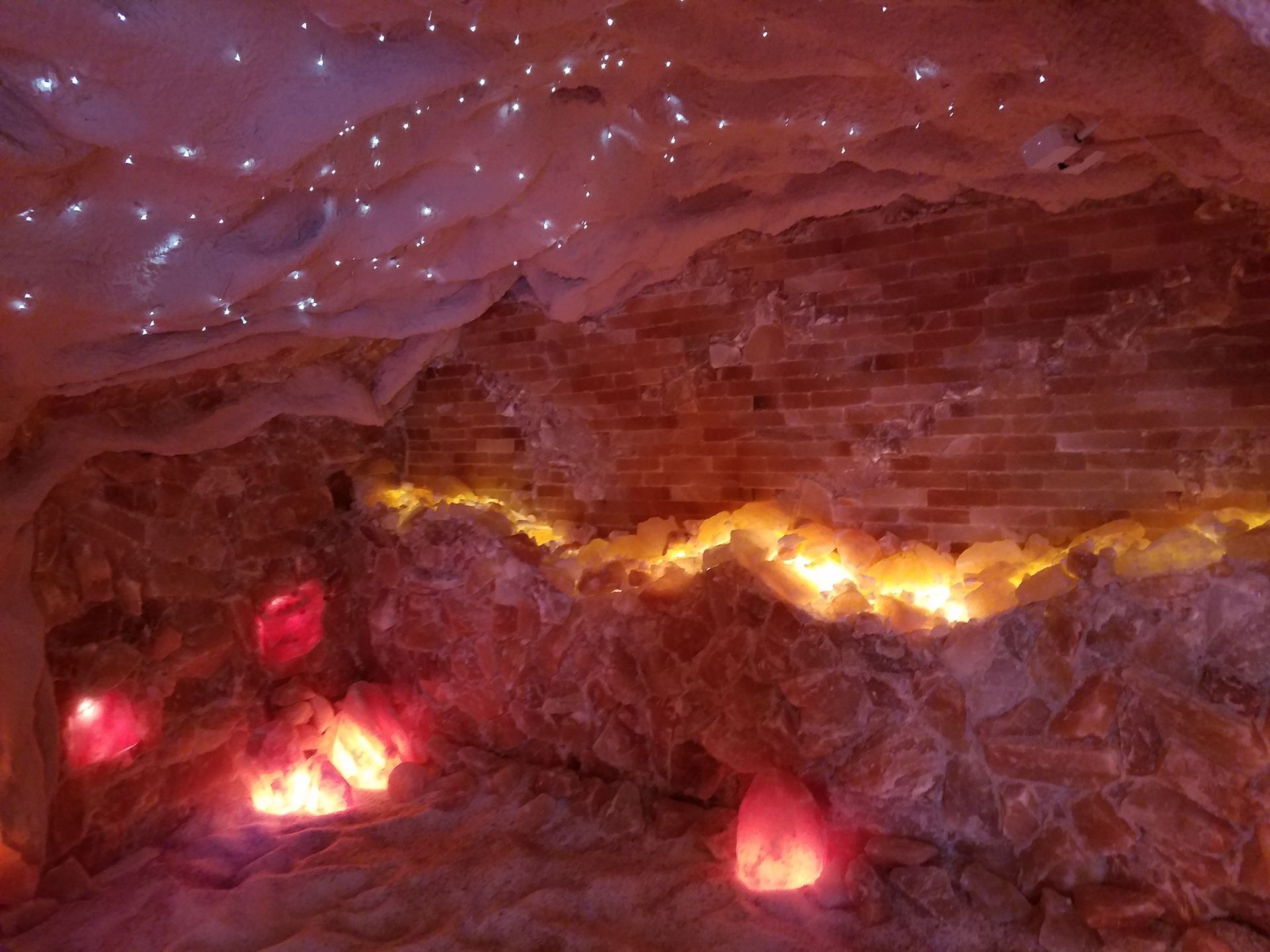 A cave with a lot of lights on the walls and ceiling