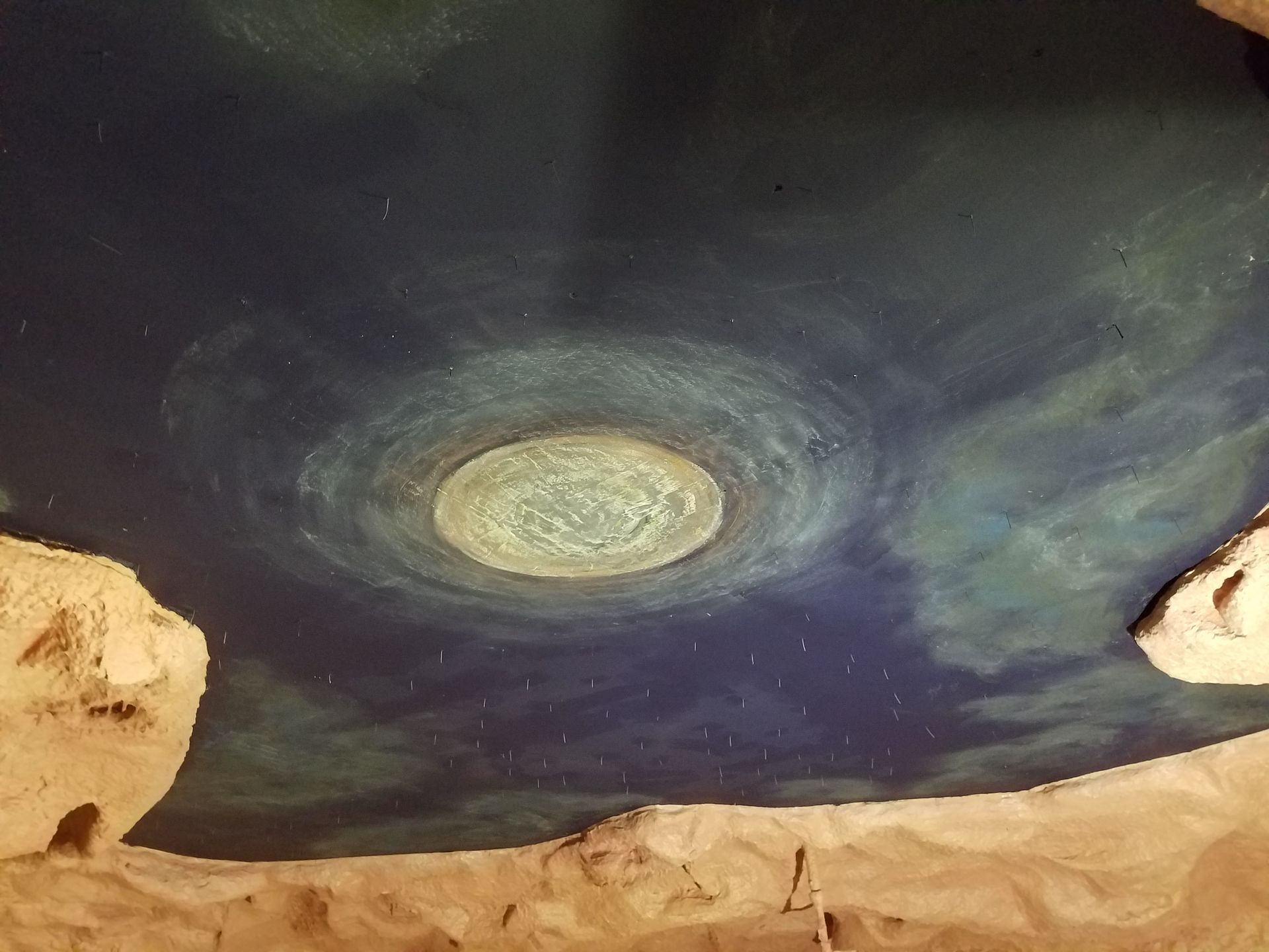 A ceiling with a picture of a galaxy on it
