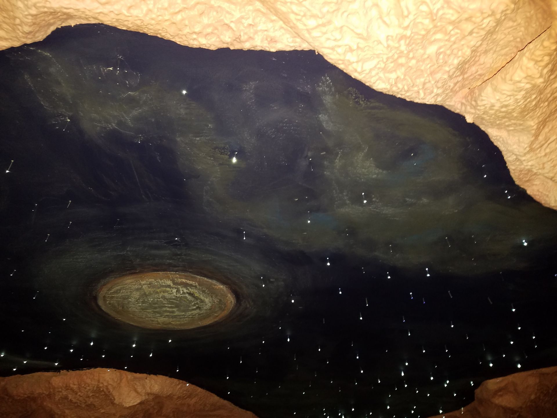 The ceiling of a cave is lit up with stars