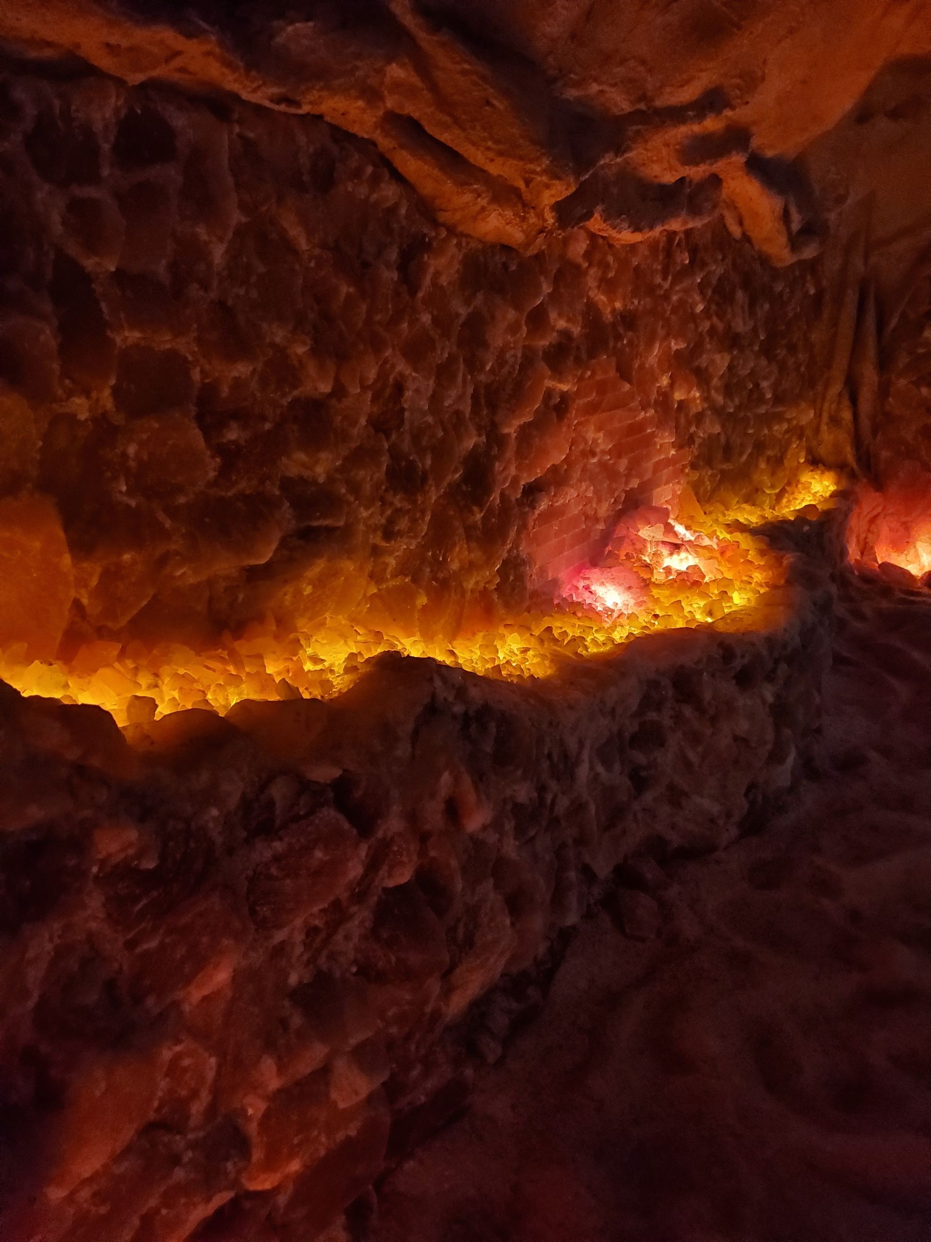 Salt cave with a lot of rocks and a light coming out of the ceiling.