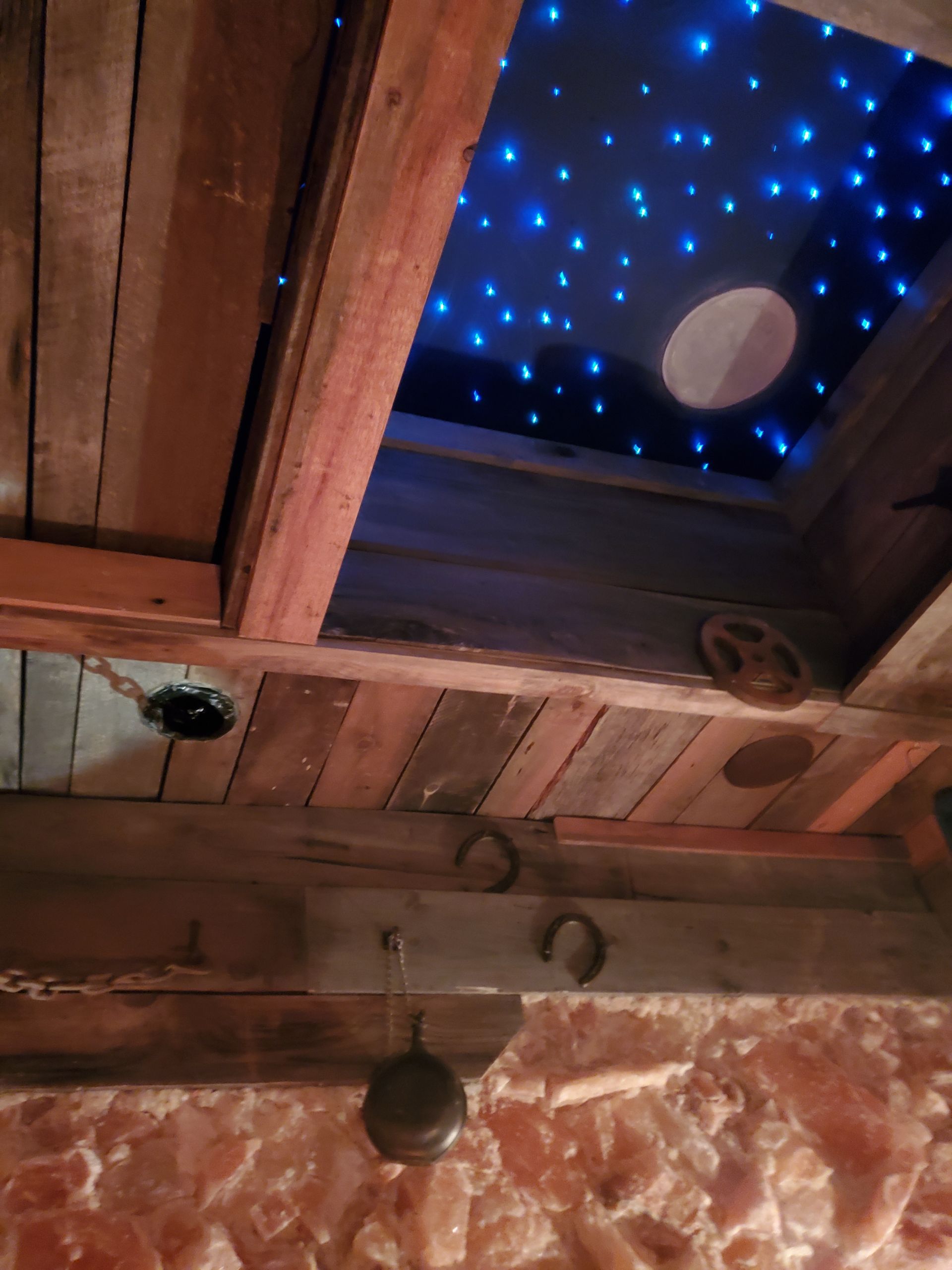 A wooden ceiling with a starry sky above it