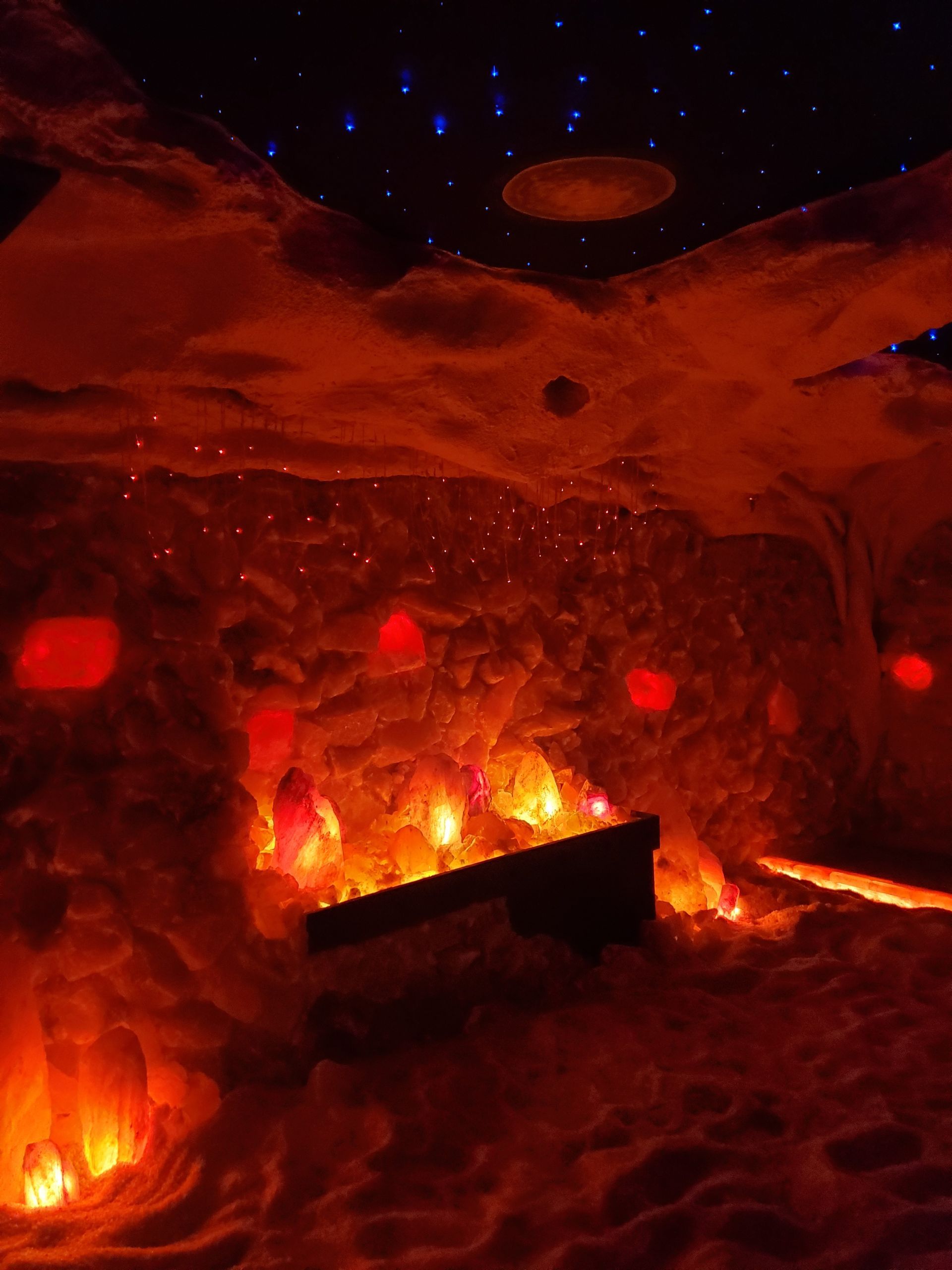 A cave filled with lots of lights and a ceiling that looks like a planet.