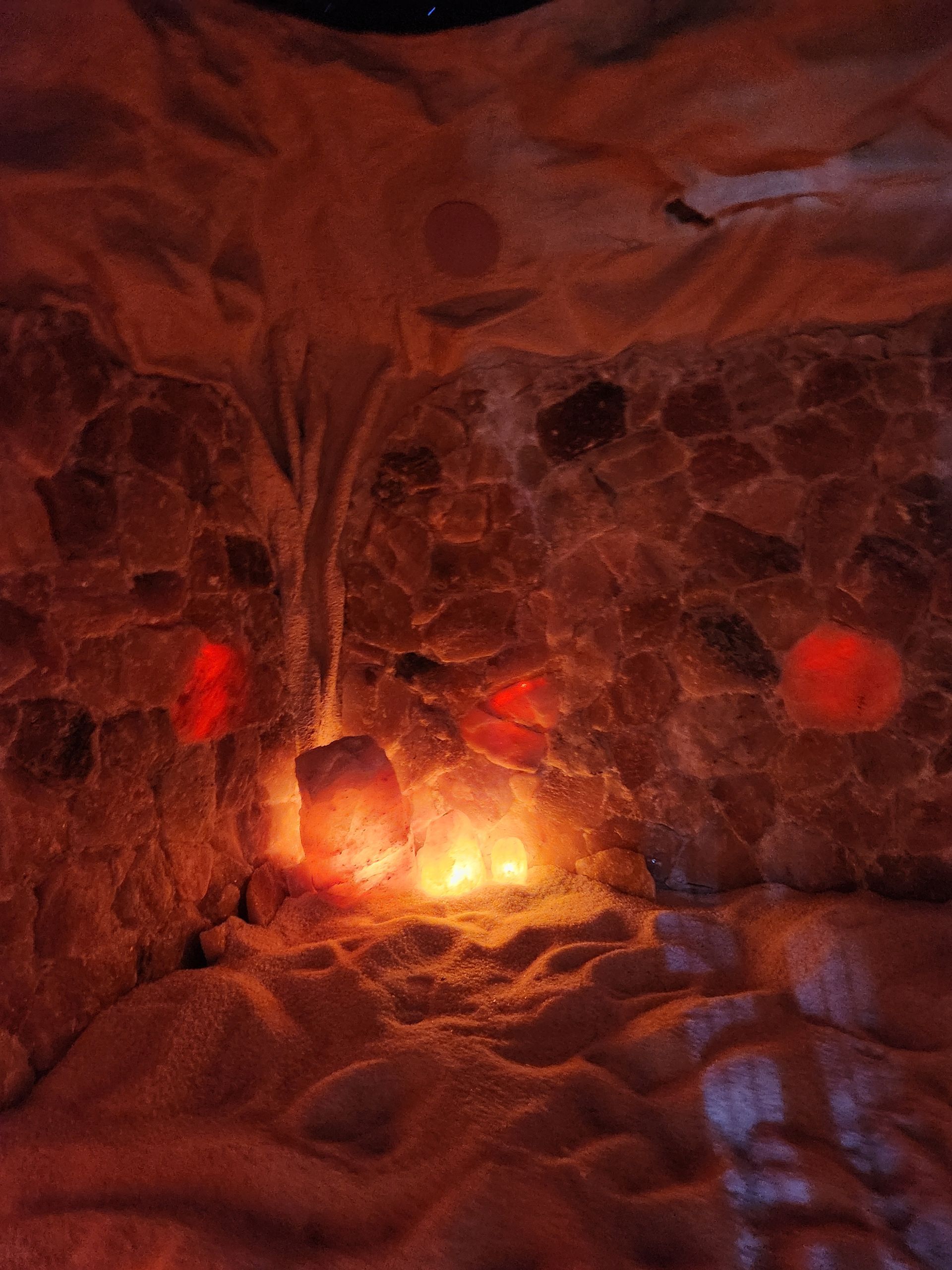 A cave filled with rocks and a light coming out of it.