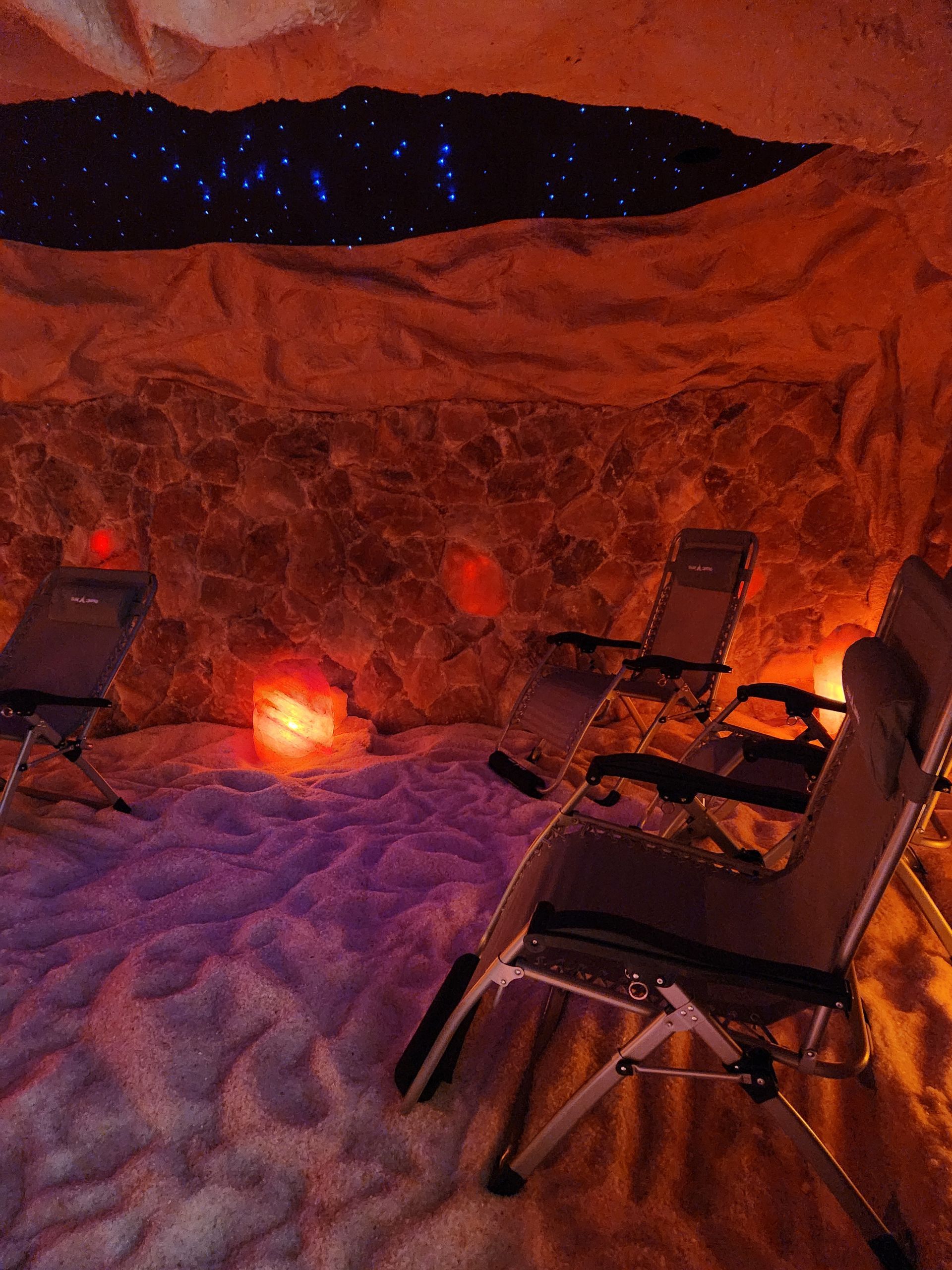 Two chairs are sitting in a cave filled with salt.