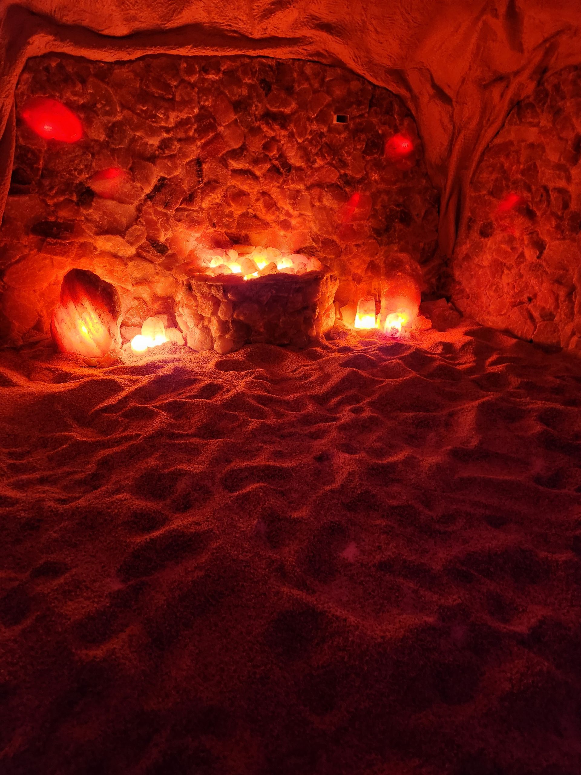 A room filled with rocks and candles in a cave.