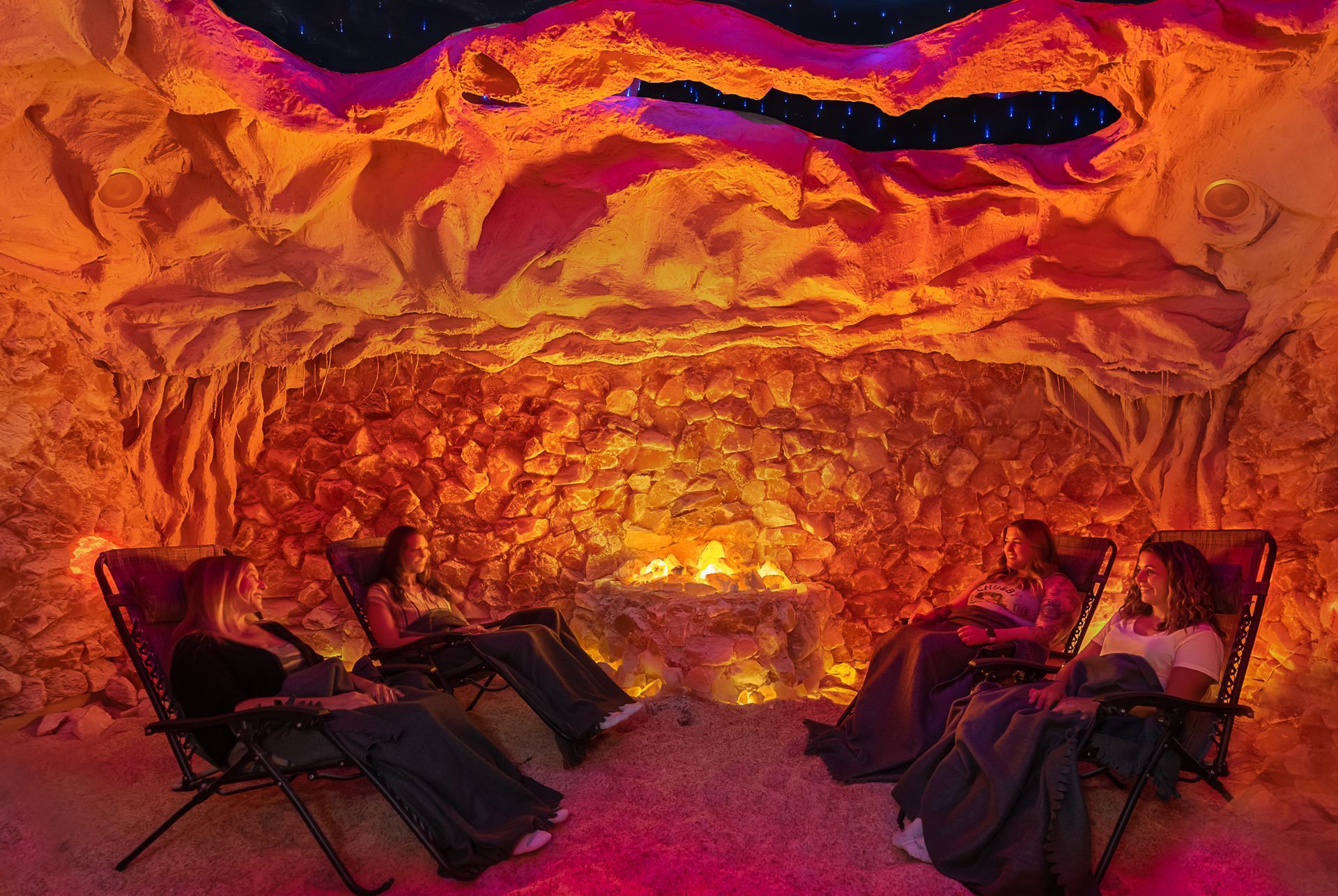 Two people are sitting in chairs in a salt cave.