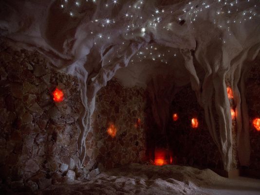 A cave with a lot of lights on the ceiling and walls.