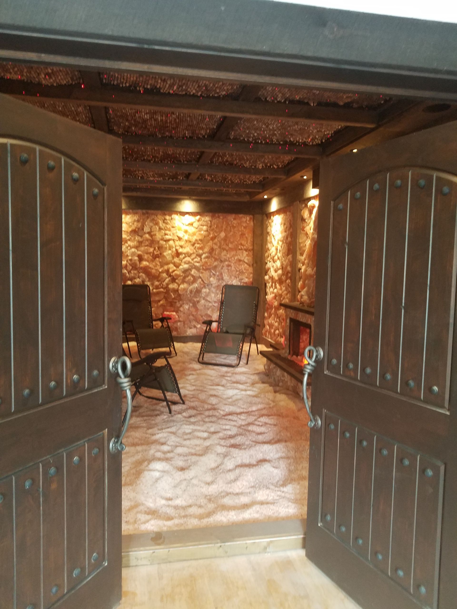 Salt cave with chairs and a fireplace in it