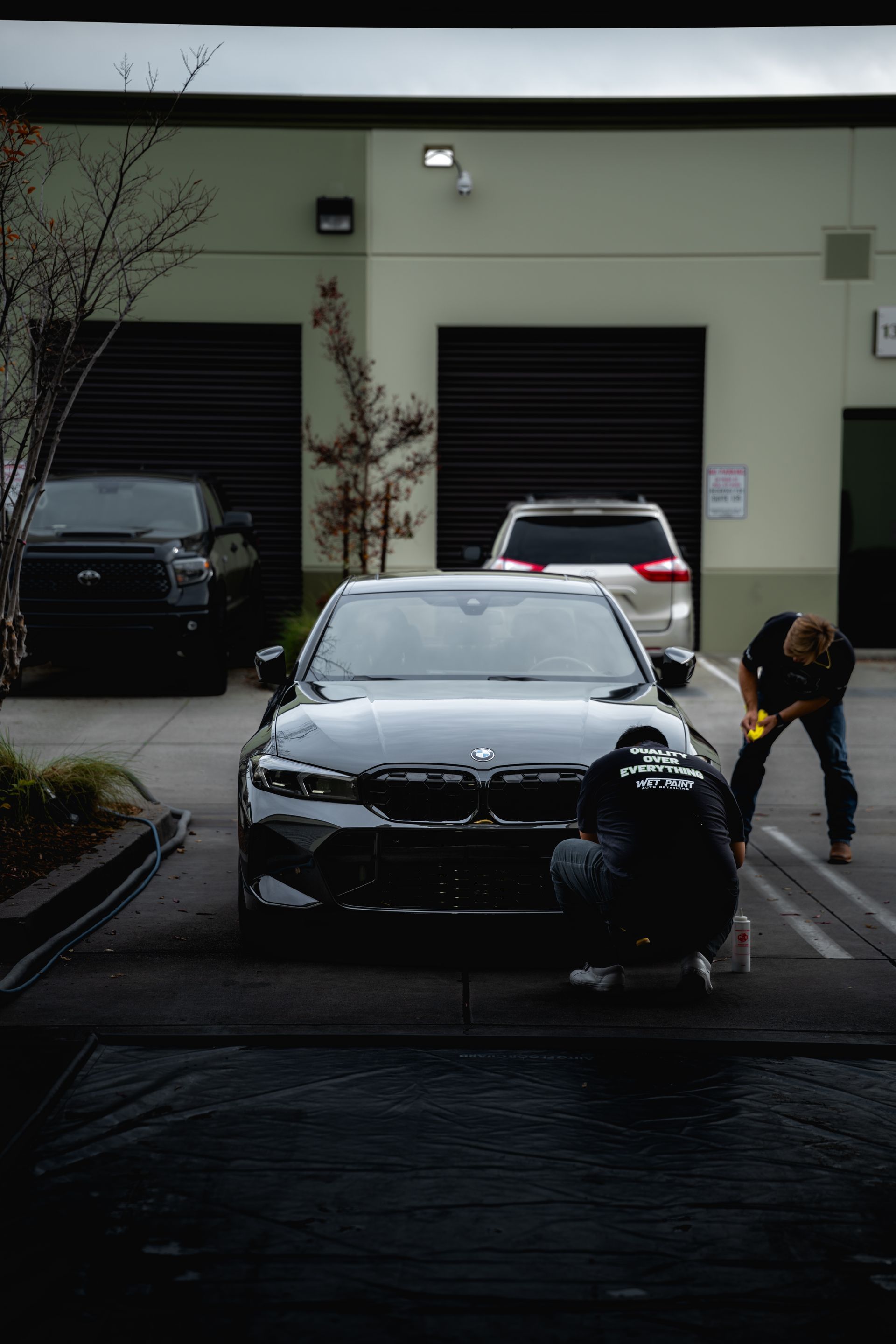 Green car being worked on inside 