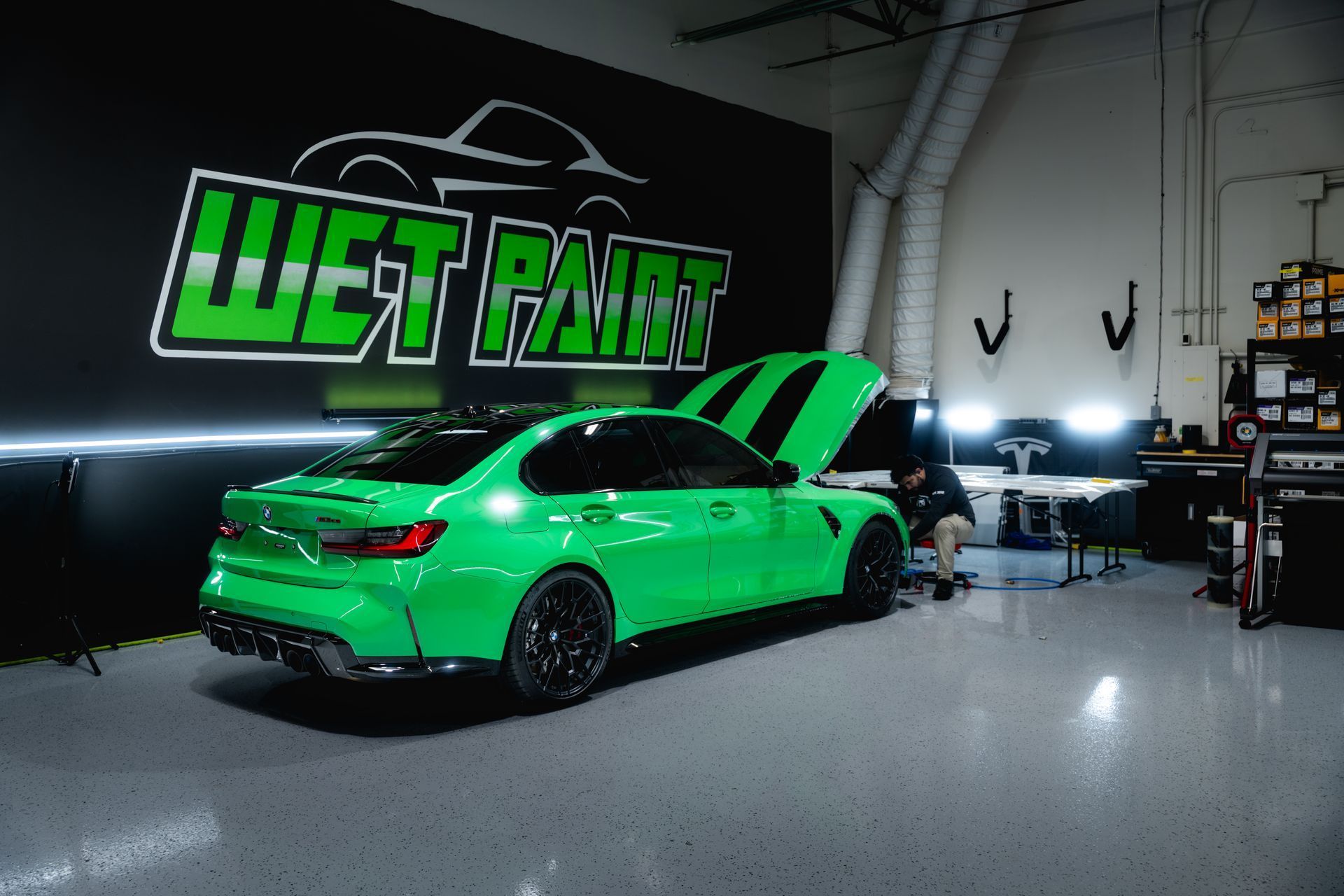 Green sports car in a garage with 