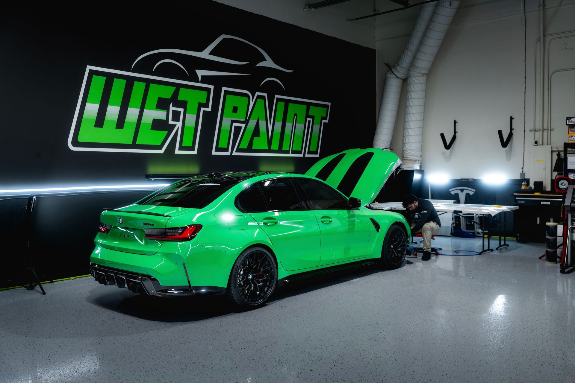 green bmw parked in a garage