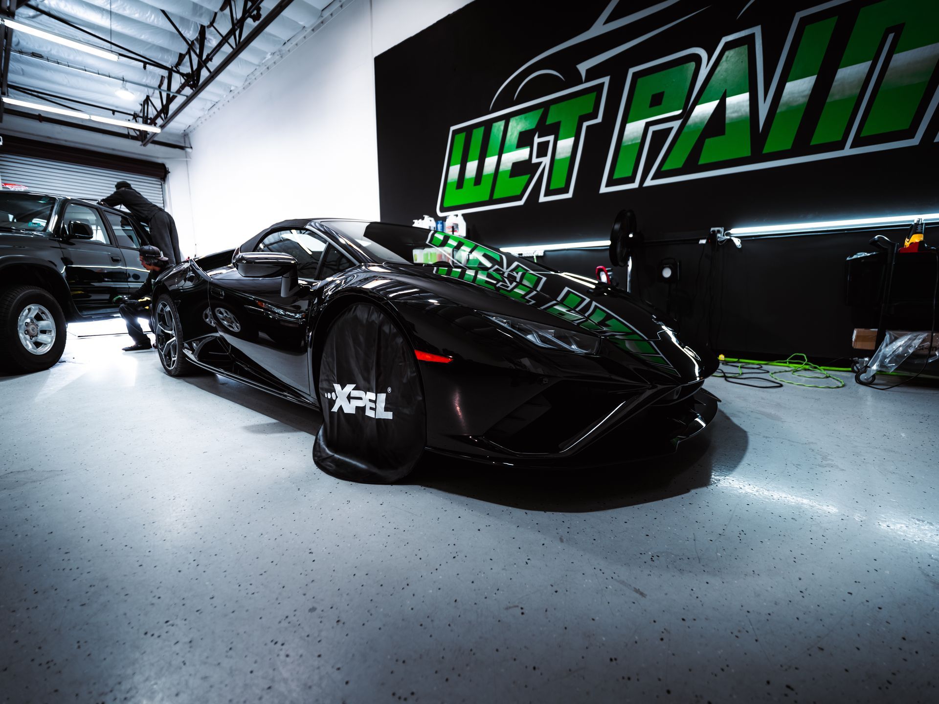 Black sports car inside a garage with