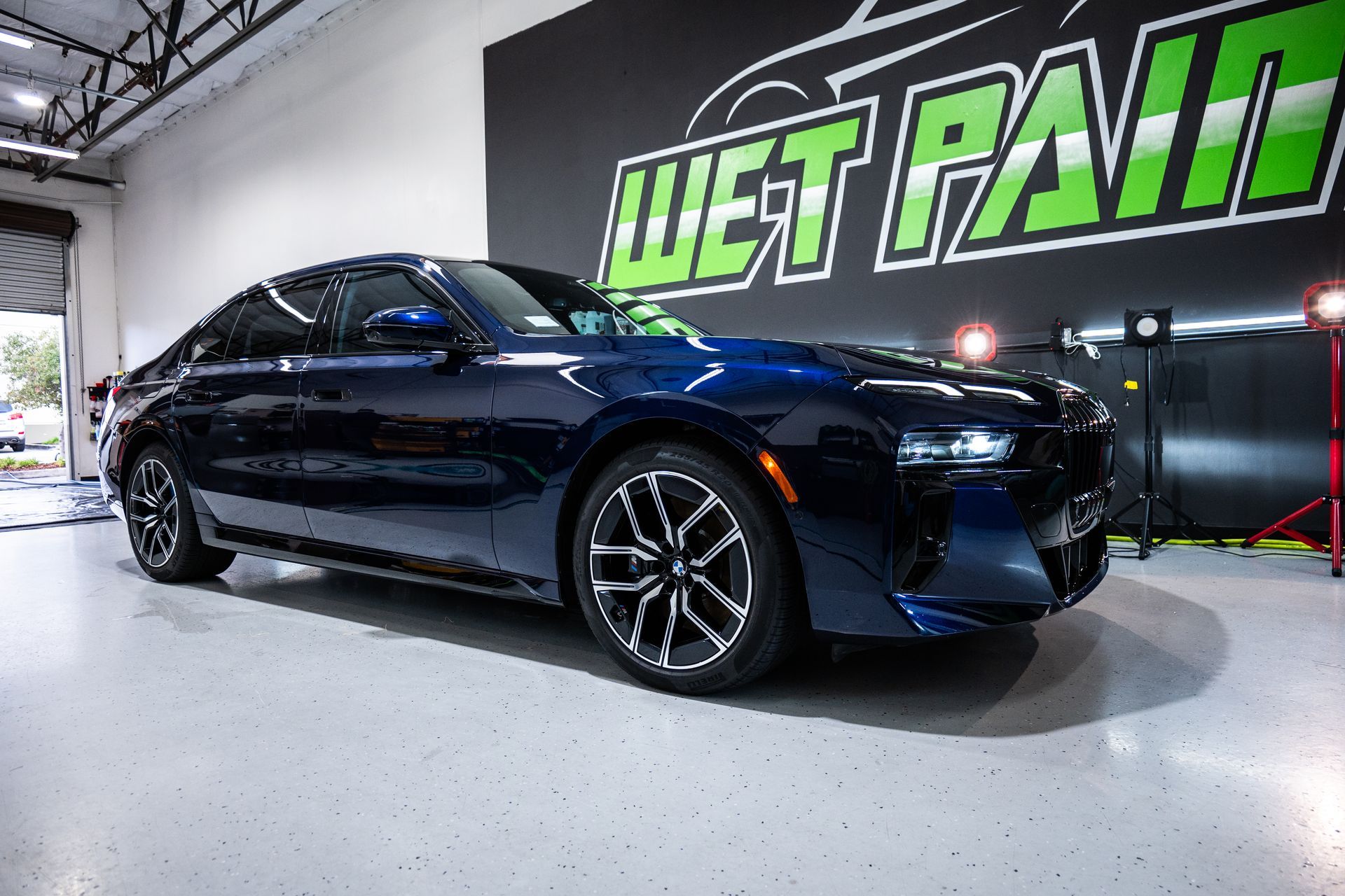 Dark blue sedan parked in a garage with 