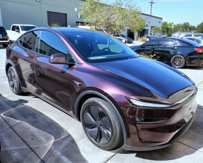 PPF applied to deep maroon Tesla Model X with glossy finish at Wet Paint Auto Detailing in Roseville
