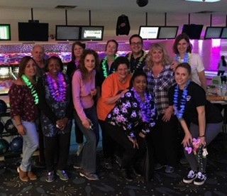 a group of people out bowling