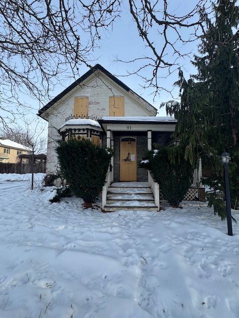 A large building with a lot of windows is sitting on the side of the road.