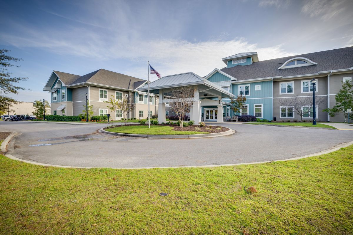 A large building with a lot of windows and a flag in front of it.