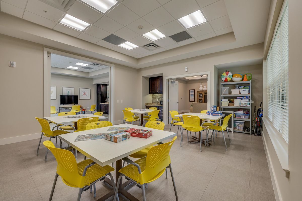 There are many tables and chairs in this room.