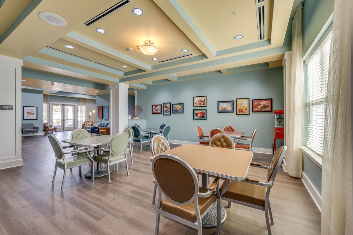 A large room with tables and chairs in it.