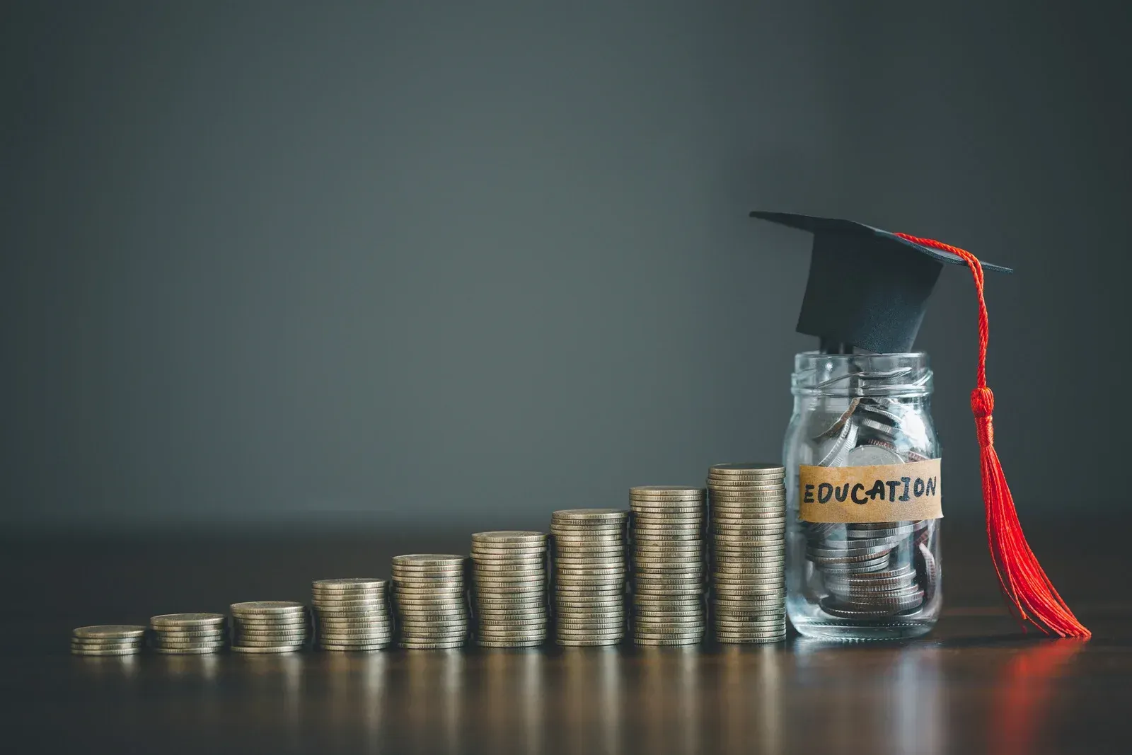 Stacks of coins ascend toward a jar labeled 