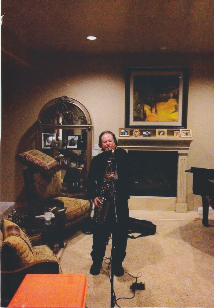 A man playing a saxophone in a living room