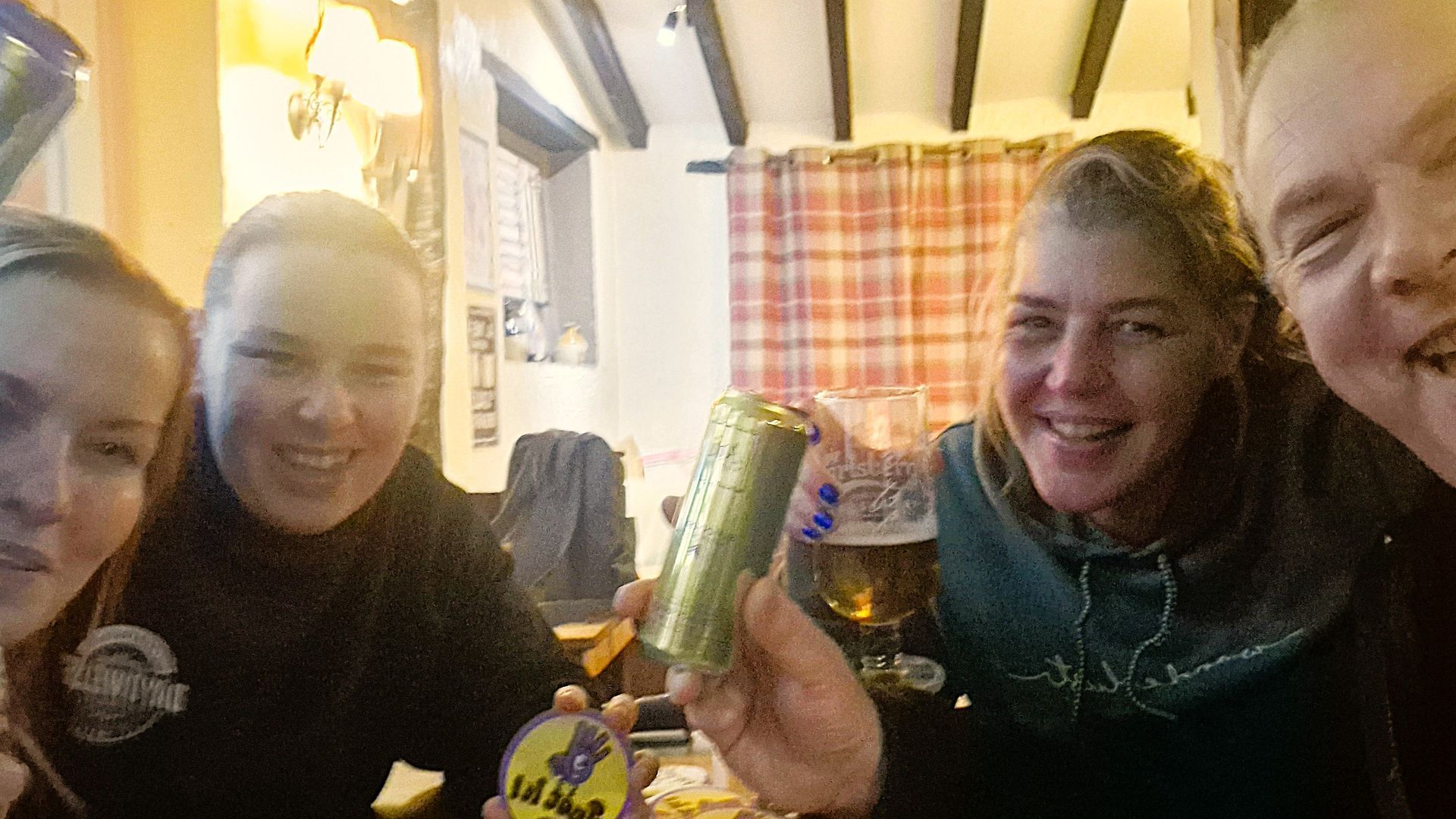 Friends playing a game in the Three Horseshoes pub