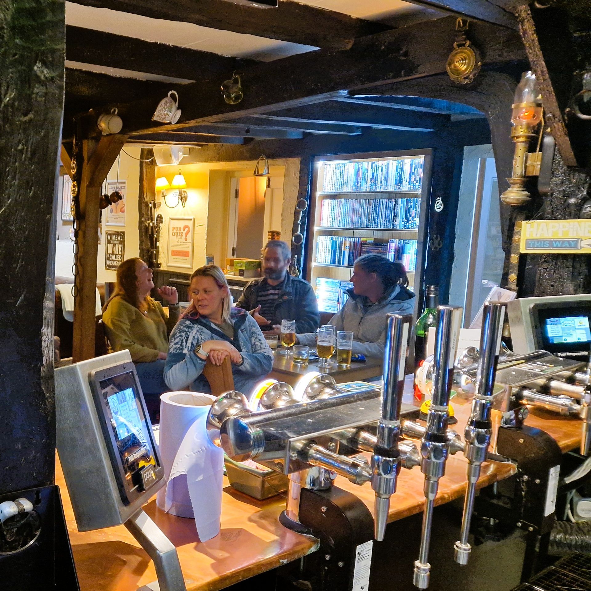 Friends sat at a table during Winter group exclusive at the Three Horseshoes