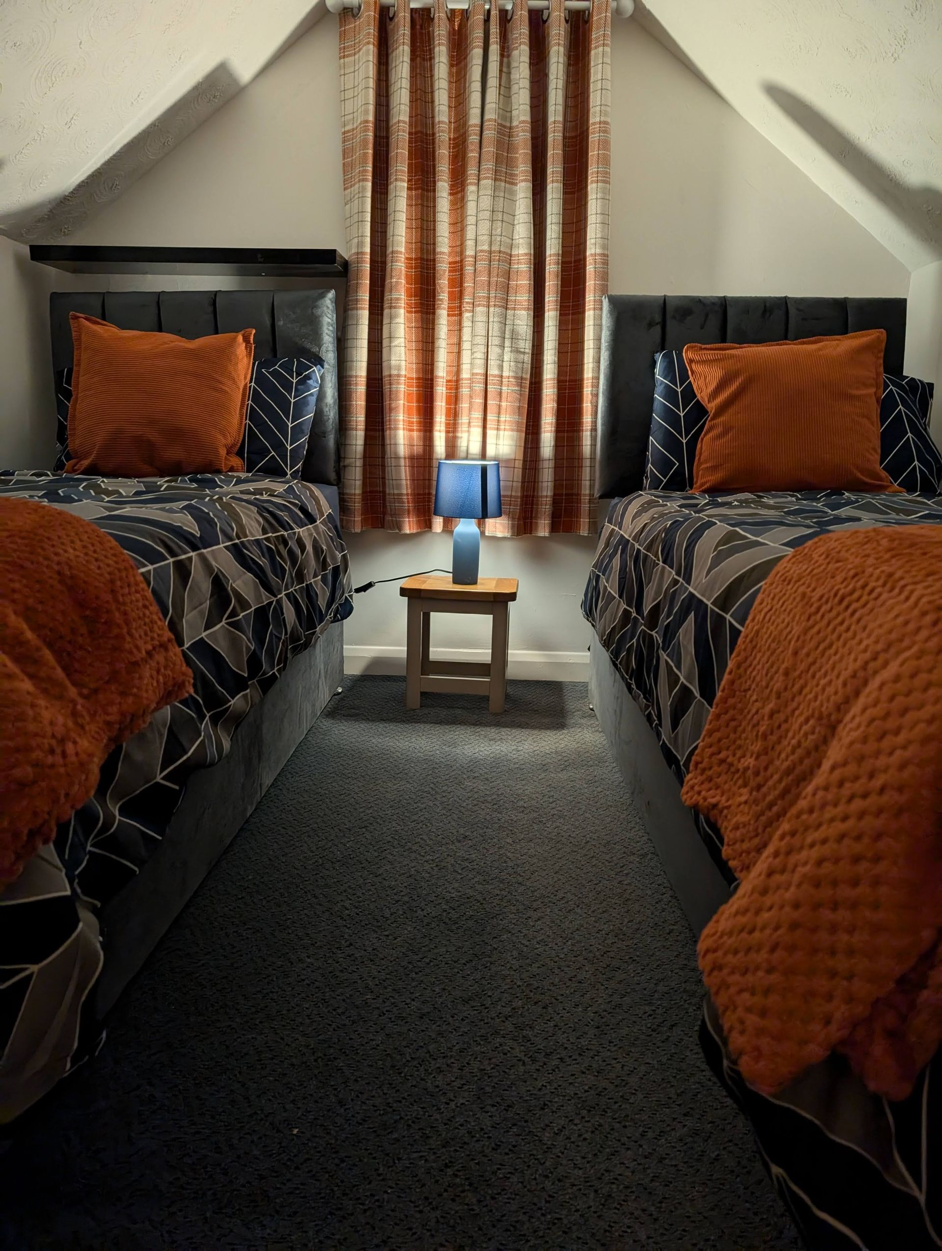 Single beds in pub flat.